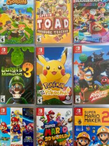 Девять игровых кейсов для Nintendo Switch, расположенных в сетке 3x3, в которых представлены такие игры, как Animal Crossing, Captain Toad, Mario Kart 8 Deluxe, Luigi's Mansion 3, Pokémon Let's Go Pikachu и другие.