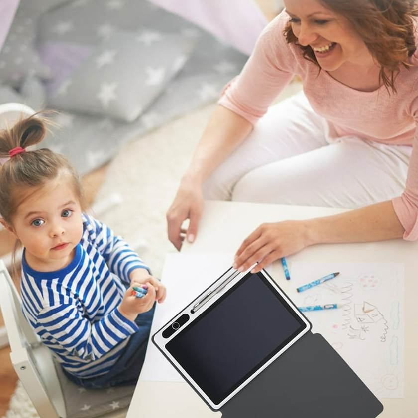 A woman and a young girl sit at a table, smiling and drawing with colored pencils. The girl, a budding child content creator, wears a striped shirt; a digital writing tablet lies nearby—a scene reflecting safe, guided digital creativity.